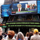 Passersby await the latest <i>Full House</i> updates in New York's Times Square Tuesday.